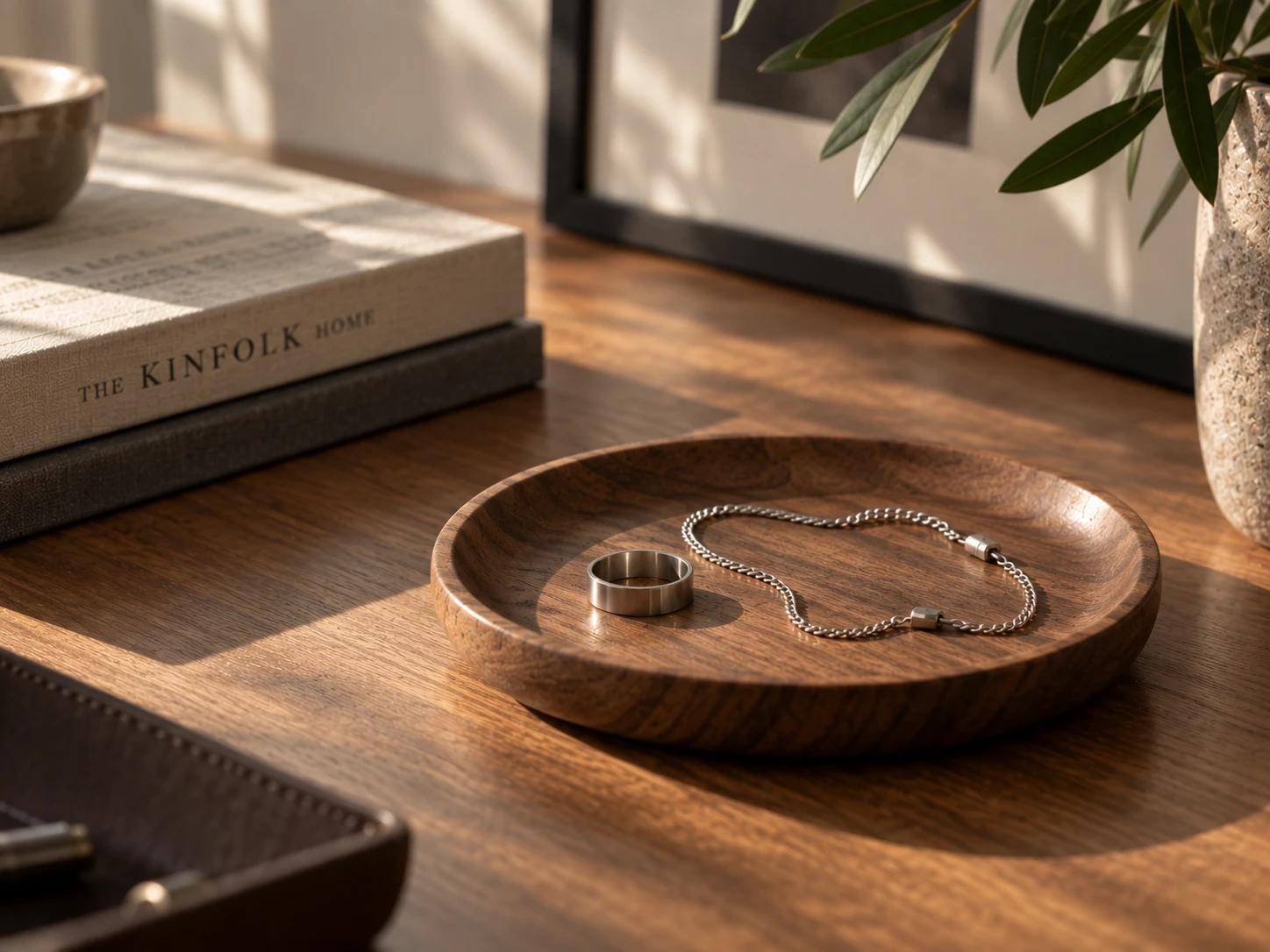 Minimalist titanium ring and chain stored on a wooden tray - LUVERIKO Journal Issue 04