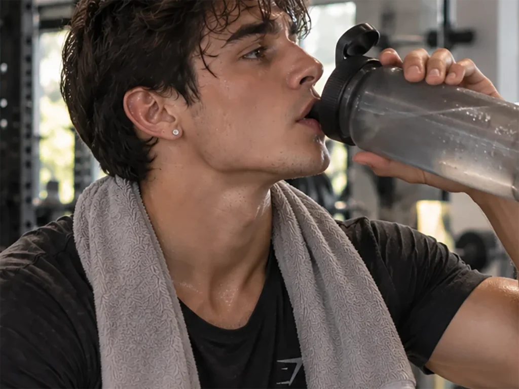 Person in a gym environment, wearing a minimalist stud earring while staying active